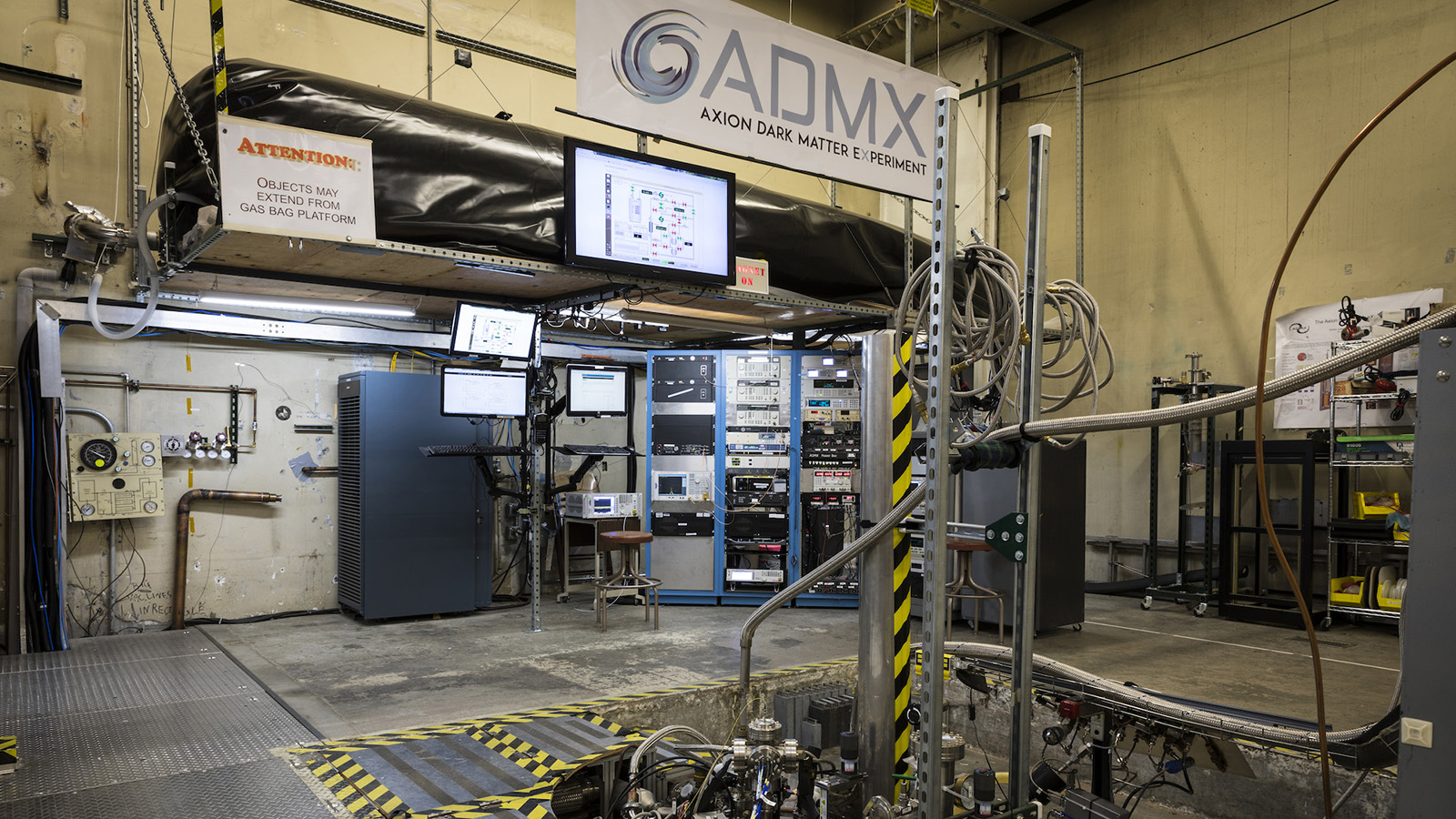 Photo of equipment and panels for the ADMX experiment fill the room: an ADMX experiment banner hangs above