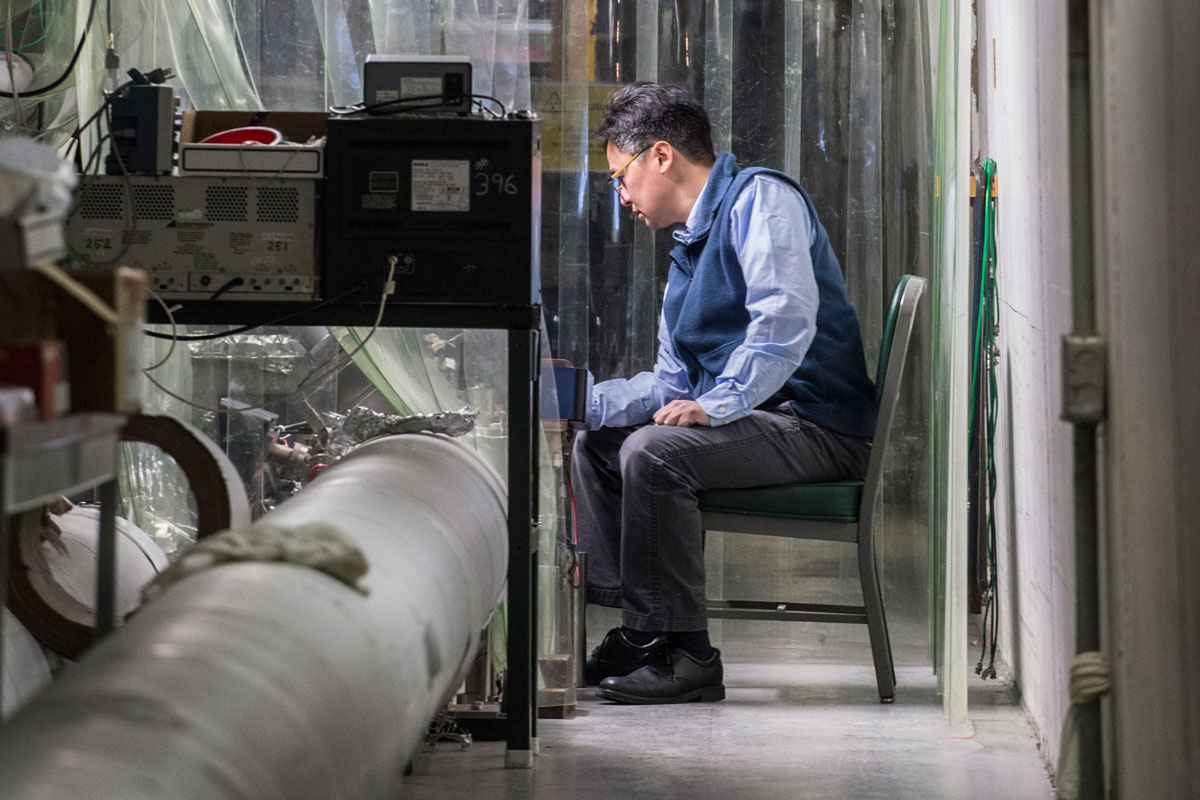 Photo of Aaron Chou, project manager  for Fermilab’s Holometer, tests the experiment’s instrumentation