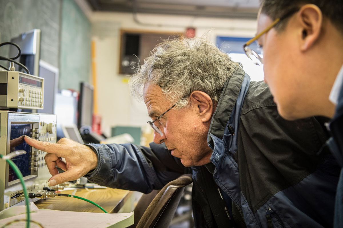 Photo of Aaron Chou looking at machine