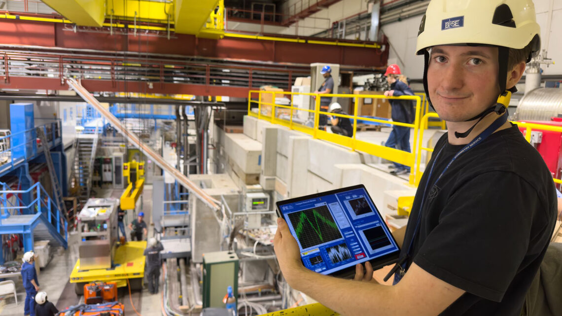 Marcel holds a tablet with data from the experiment