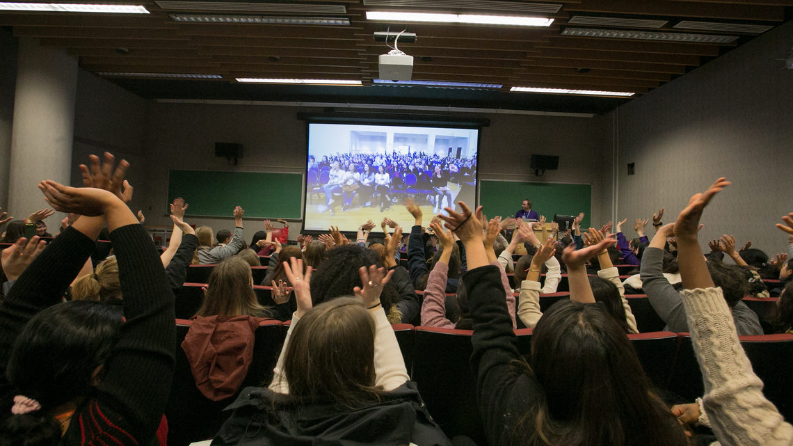 Before the beginning of the shared video keynote talk, attendees at each CUWiP site cheer and wave on video.