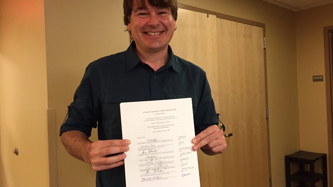 Dan Rederth hands in his dissertation