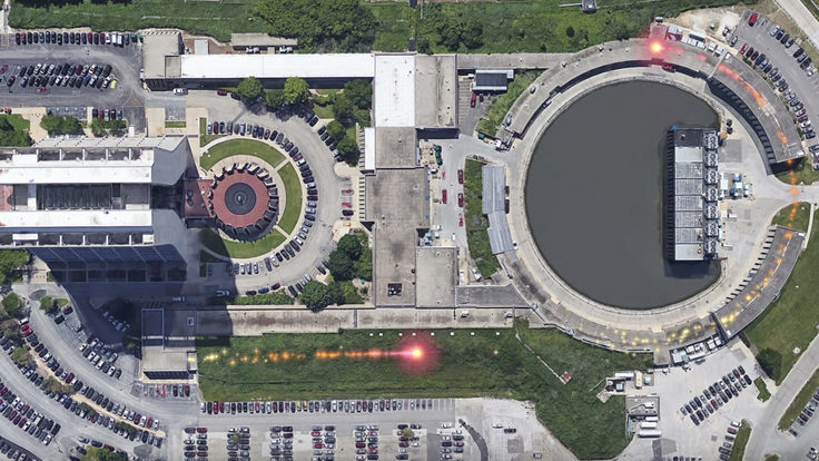 Two pink trails, representing particles, show the motion of particles passing through the accelerator complex.